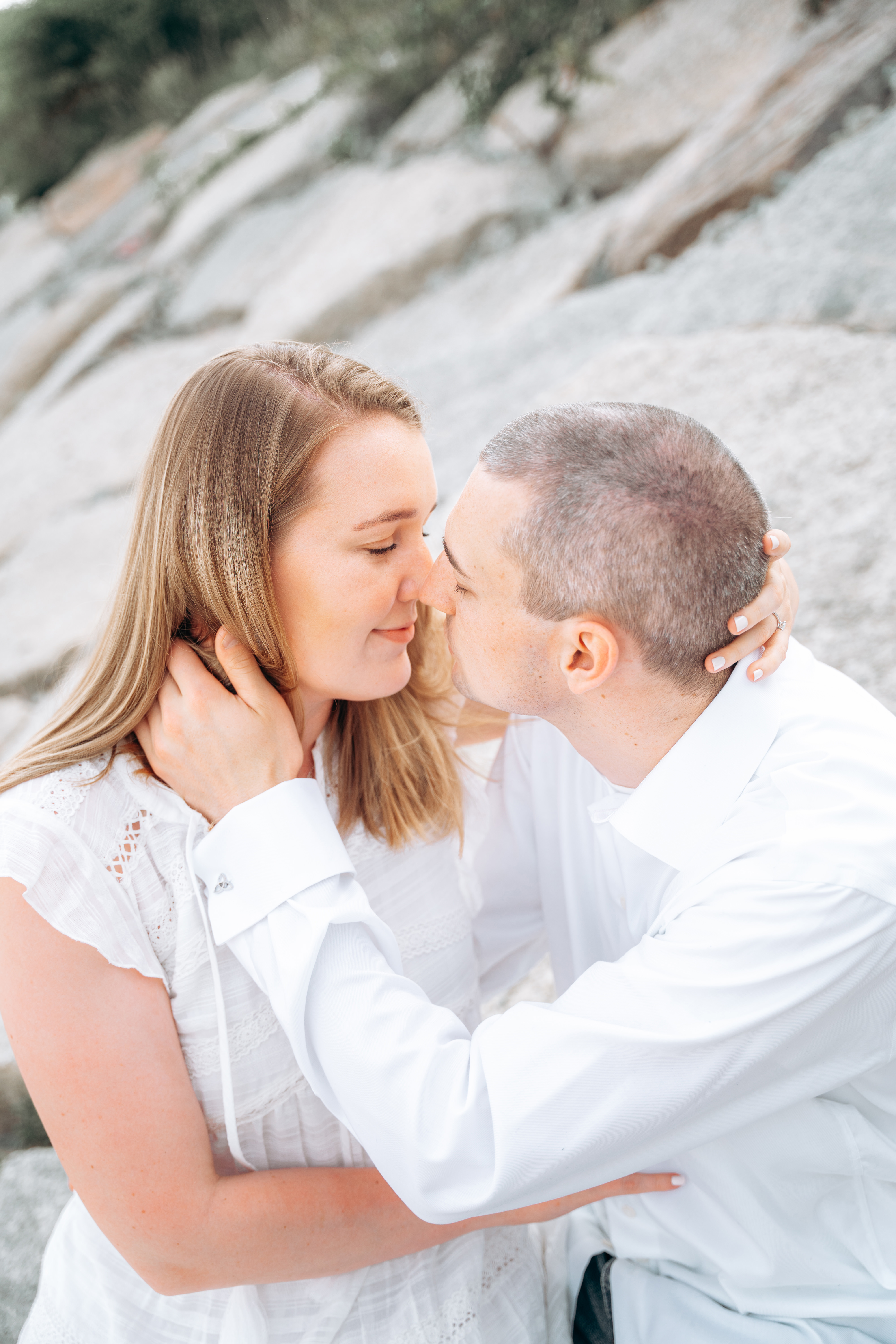 Ciara and Pat — intimate moment against rocky wall